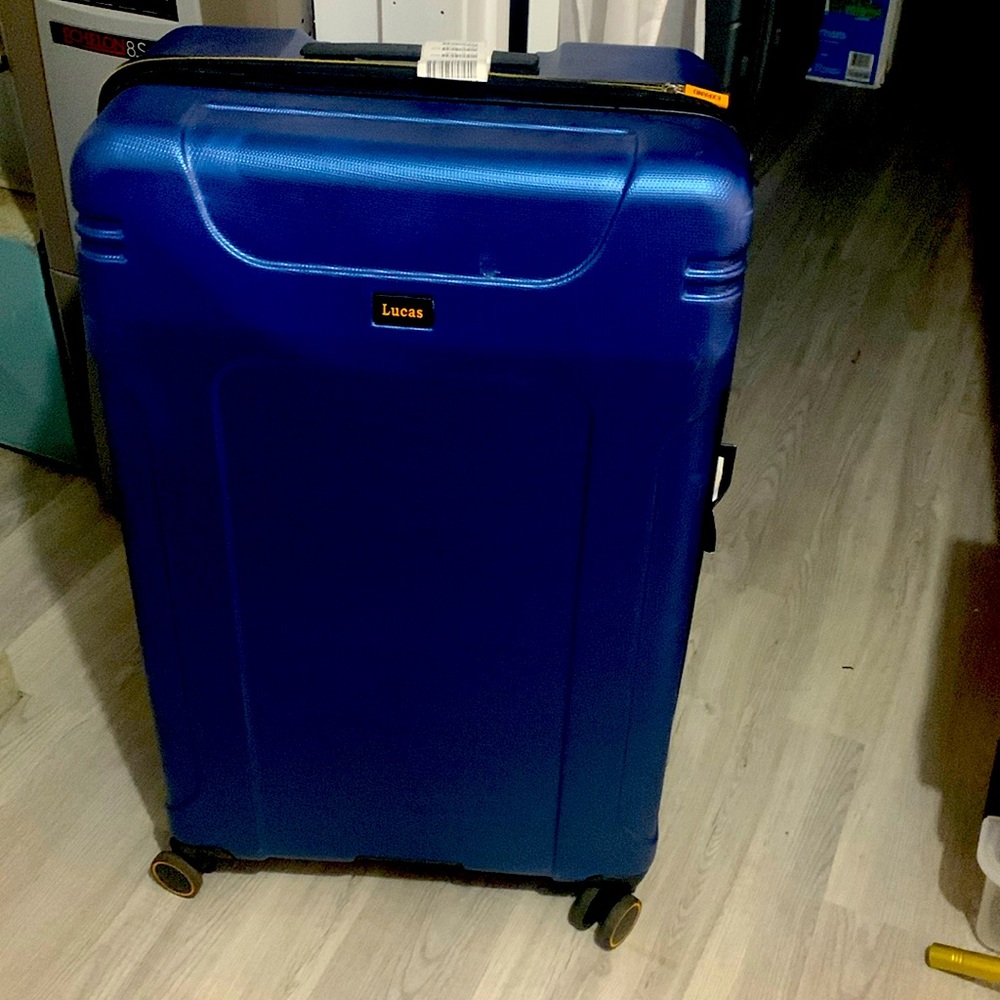 Large blue hard shell suitcase with wheels